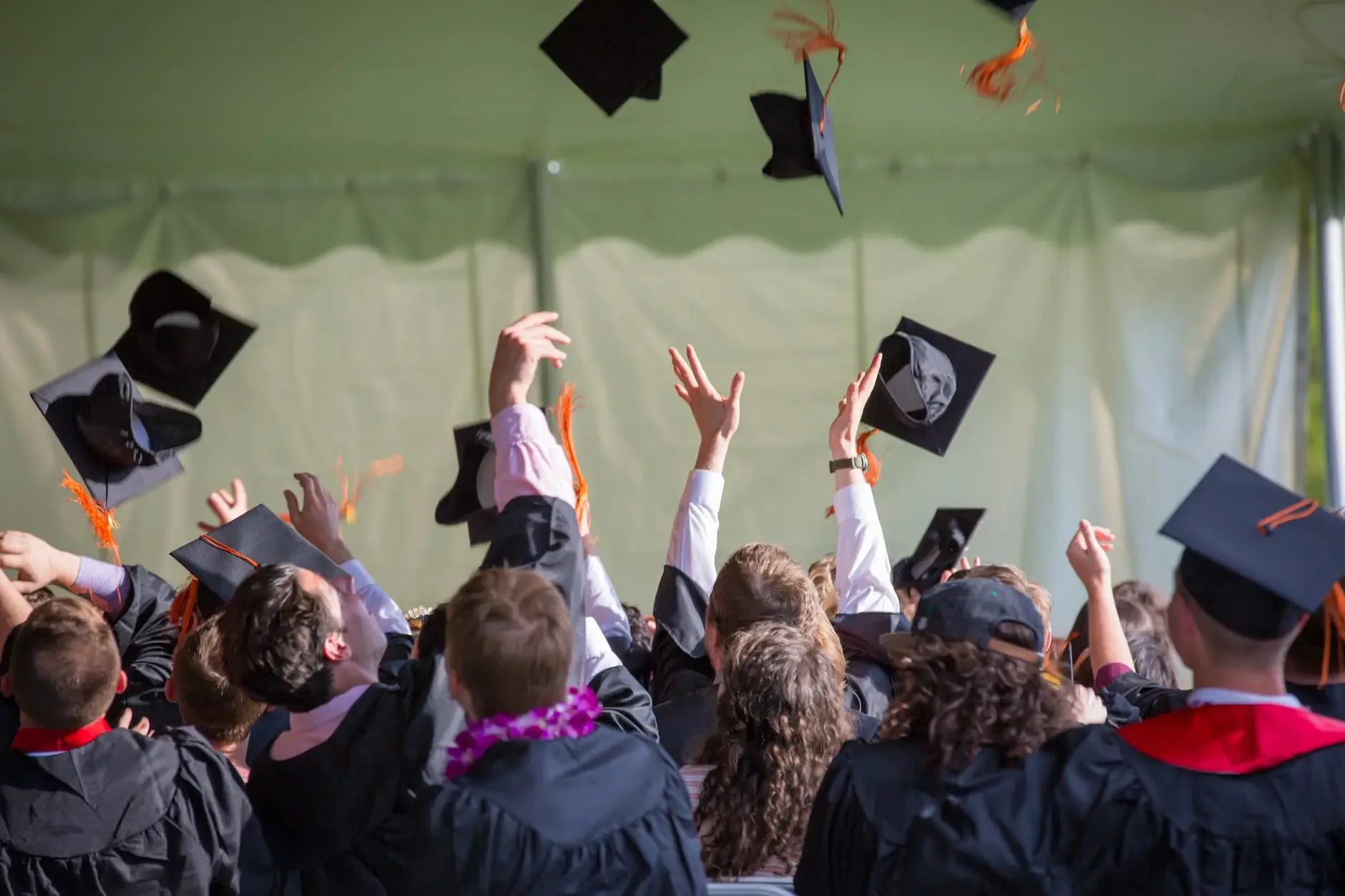 students throw their hats in the air